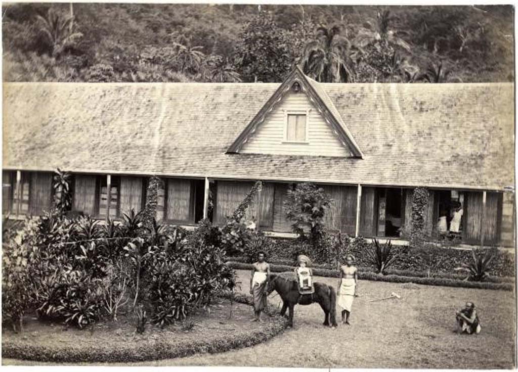 “A small child, possibly the Governor’s son, Jack, seated on a pony with two Fijian attendants in front of Government House in Nasova, Ovalau Island, Fiji”. Source: collected by A. von Hügel, 1875-77, Museum of archaeology and anthropology, P.99680.VH, http://maa.cam.ac.uk/photo-government-house-p-99680-vh/